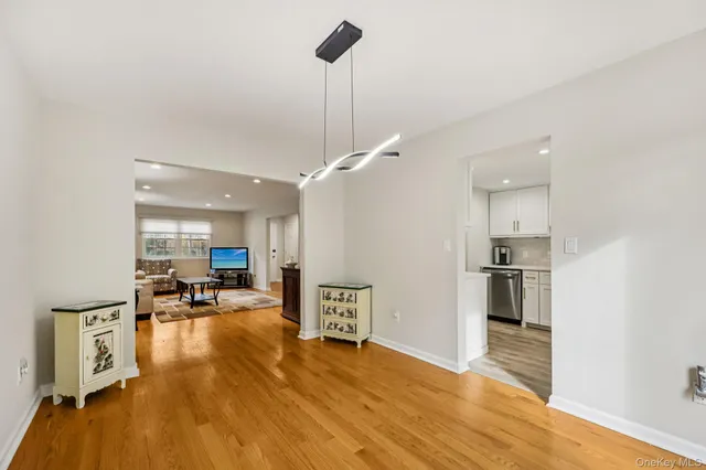 a view of a kitchen with furniture and wooden floor