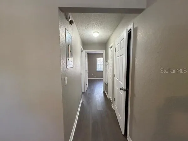 a view of hallway with wooden floor