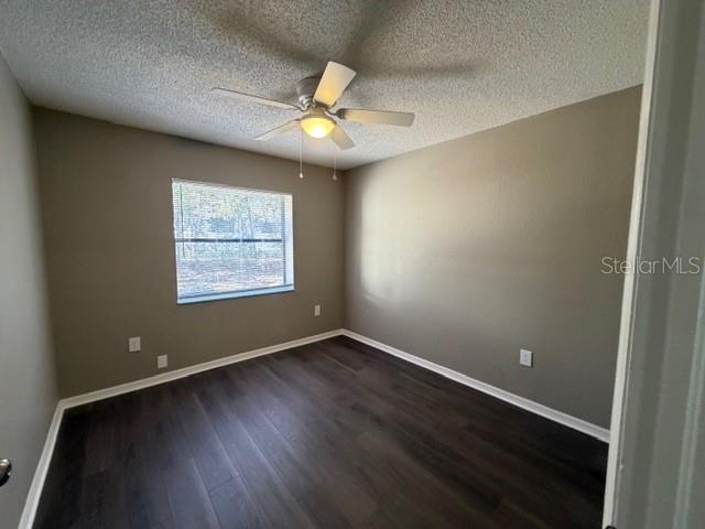 4400 Millwood Road, Unit E Spring Hill, FL 34608 - Photo 16 of 21 an empty room with wooden floor fan and windows