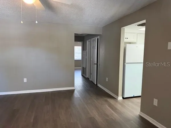a view of a room with wooden floor