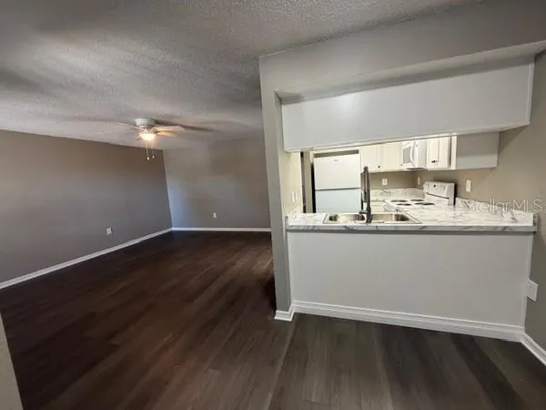 a room with wooden floor and sink