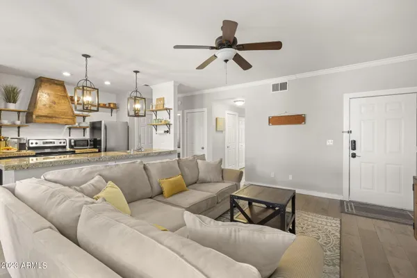 a living room with furniture and kitchen view
