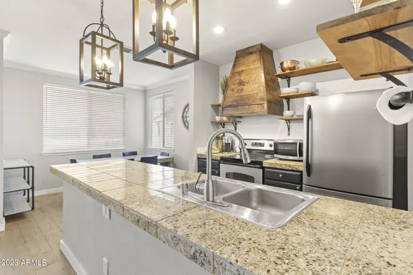 a kitchen with granite countertop lots of counter top space and stainless steel appliances
