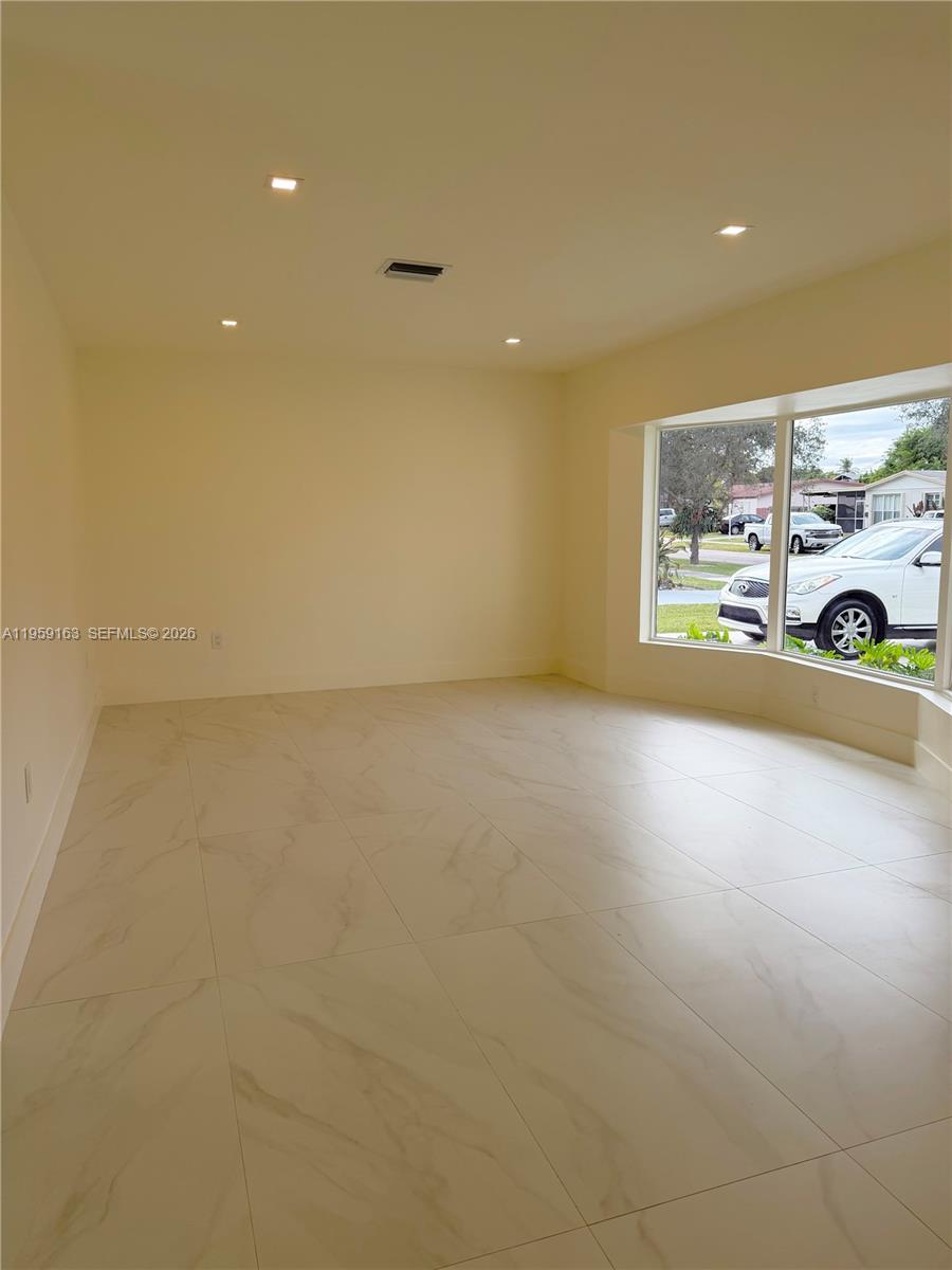 19221 Southwest 92nd Road Cutler Bay, FL 33157 - Photo 5 of 30 a view of an empty room with a window