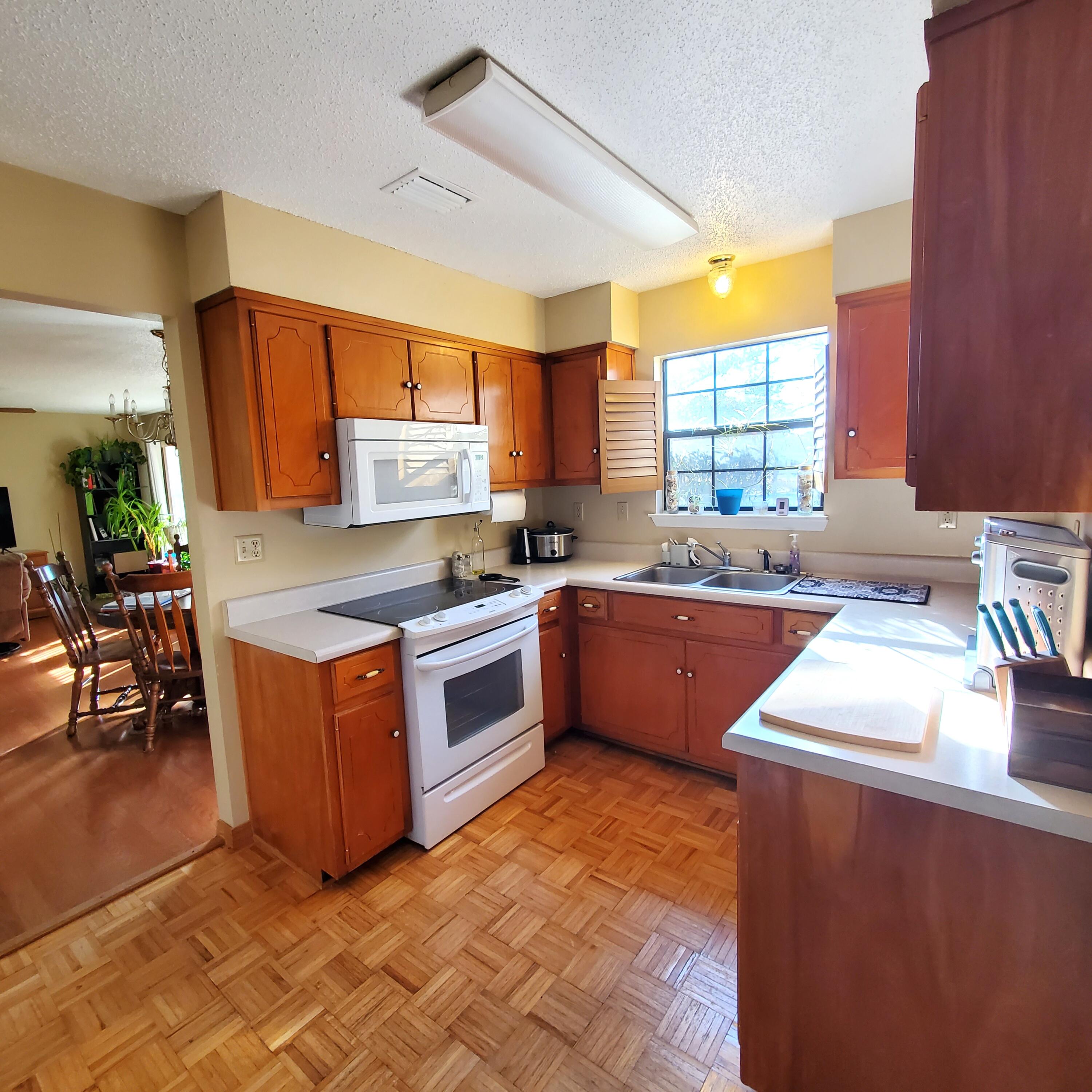 6060 Old Bethel Road Crestview, FL 32536 - Photo 12 of 25 a kitchen with stainless steel appliances granite countertop a sink counter space and a window