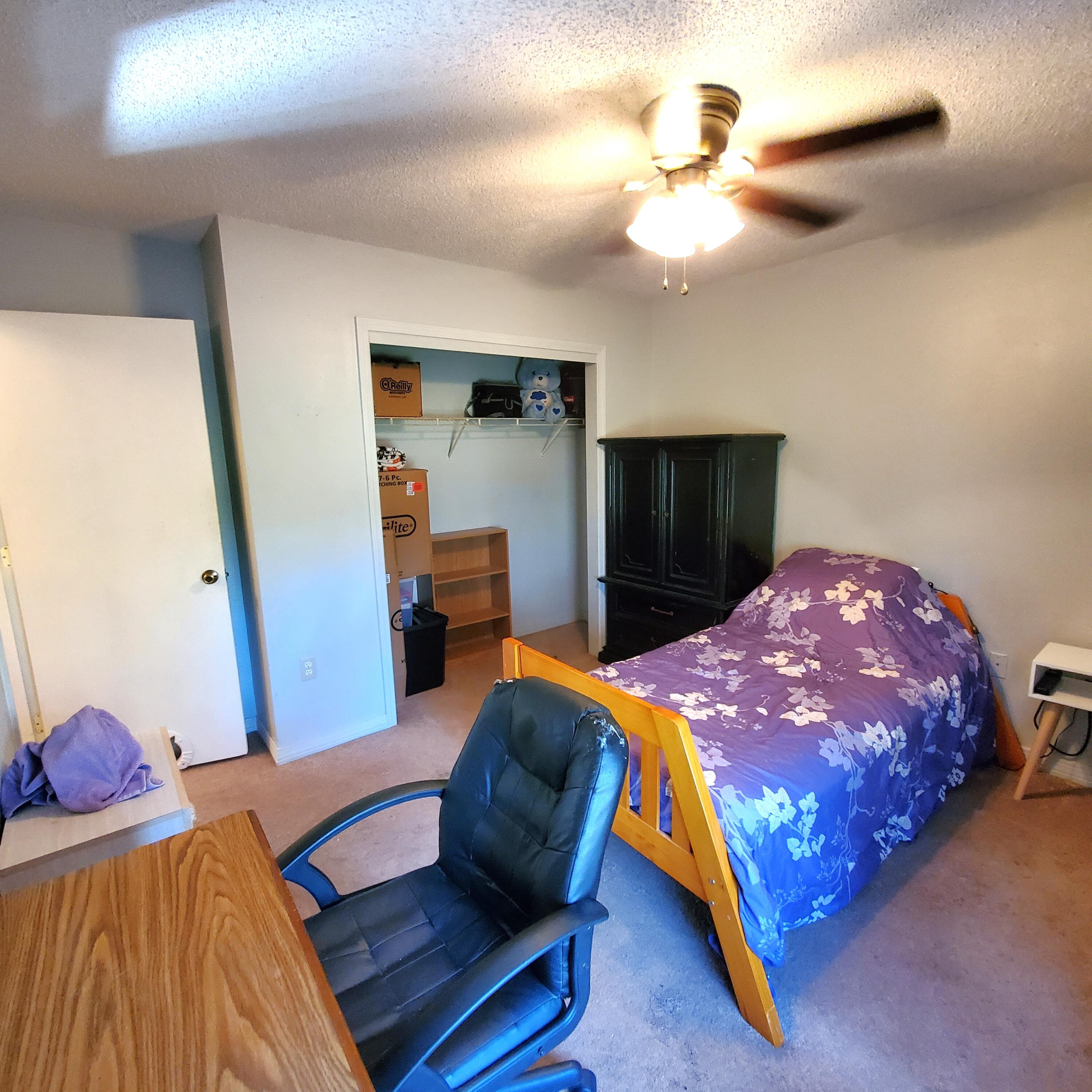 6060 Old Bethel Road Crestview, FL 32536 - Photo 16 of 25 a bedroom with a bed and a chandelier
