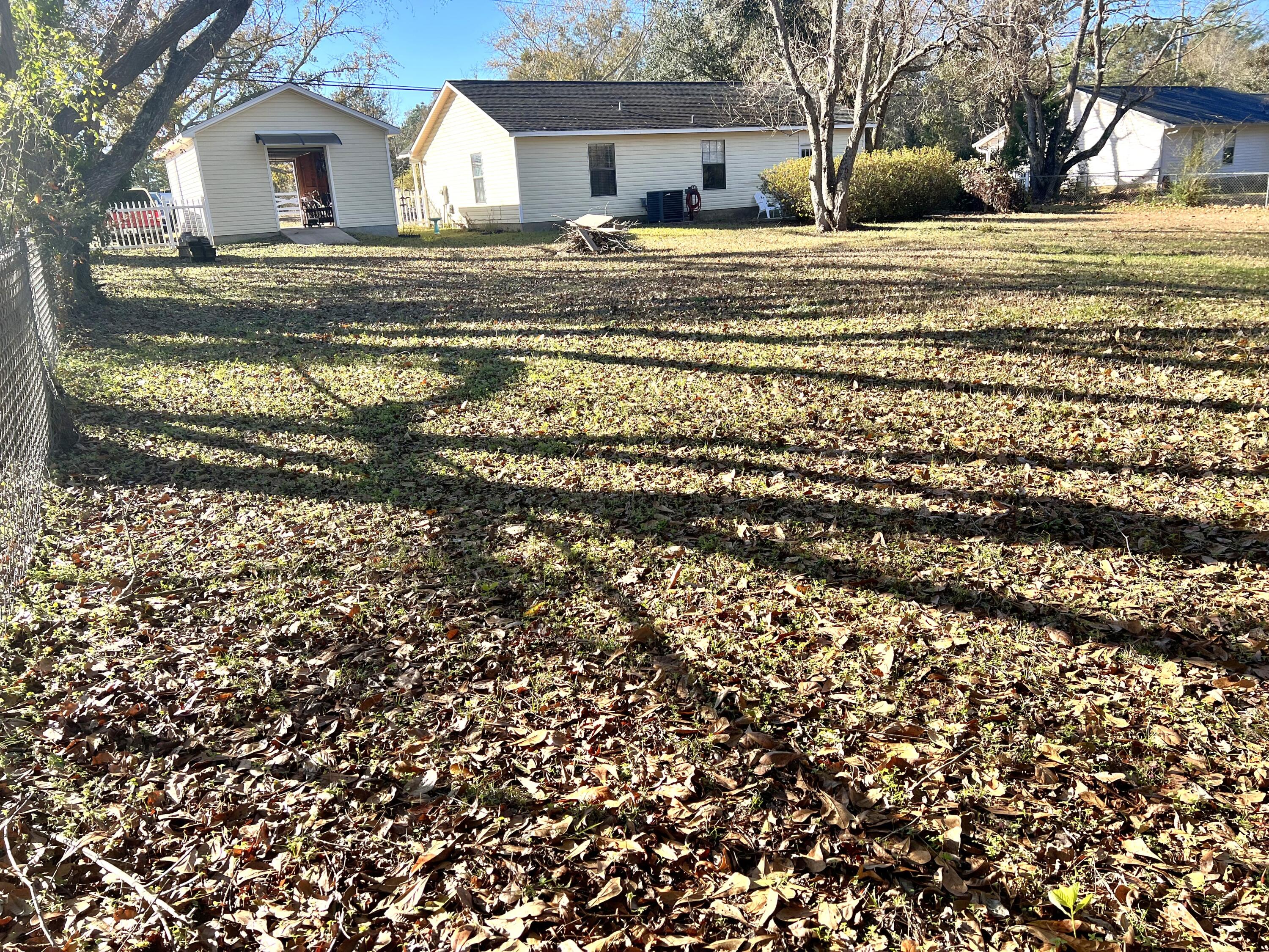 6060 Old Bethel Road Crestview, FL 32536 - Photo 24 of 25 a view of a house with a yard covered in the trees