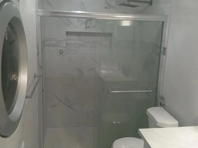 a bathroom with a shower and toilet
