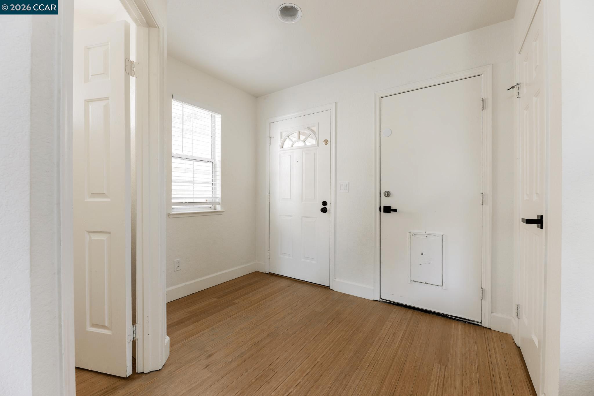 528 Dohrmann Lane Pinole, CA 94564 - Photo 12 of 27 a view of an empty room with wooden floor and a window