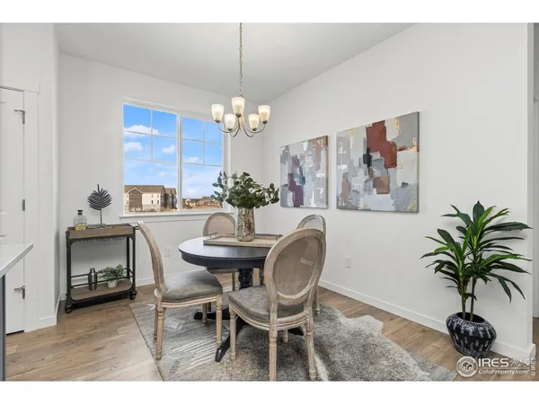 a view of a dining room with furniture and chandelier