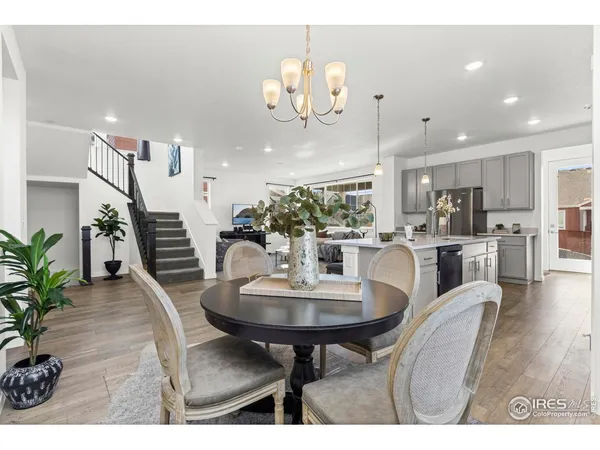 a dining room with furniture and wooden floor