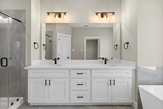 a bathroom with a double vanity sink and mirror
