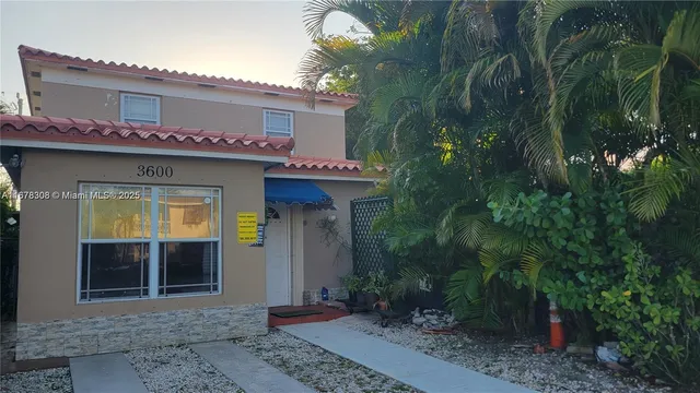 a view of a house with potted plants