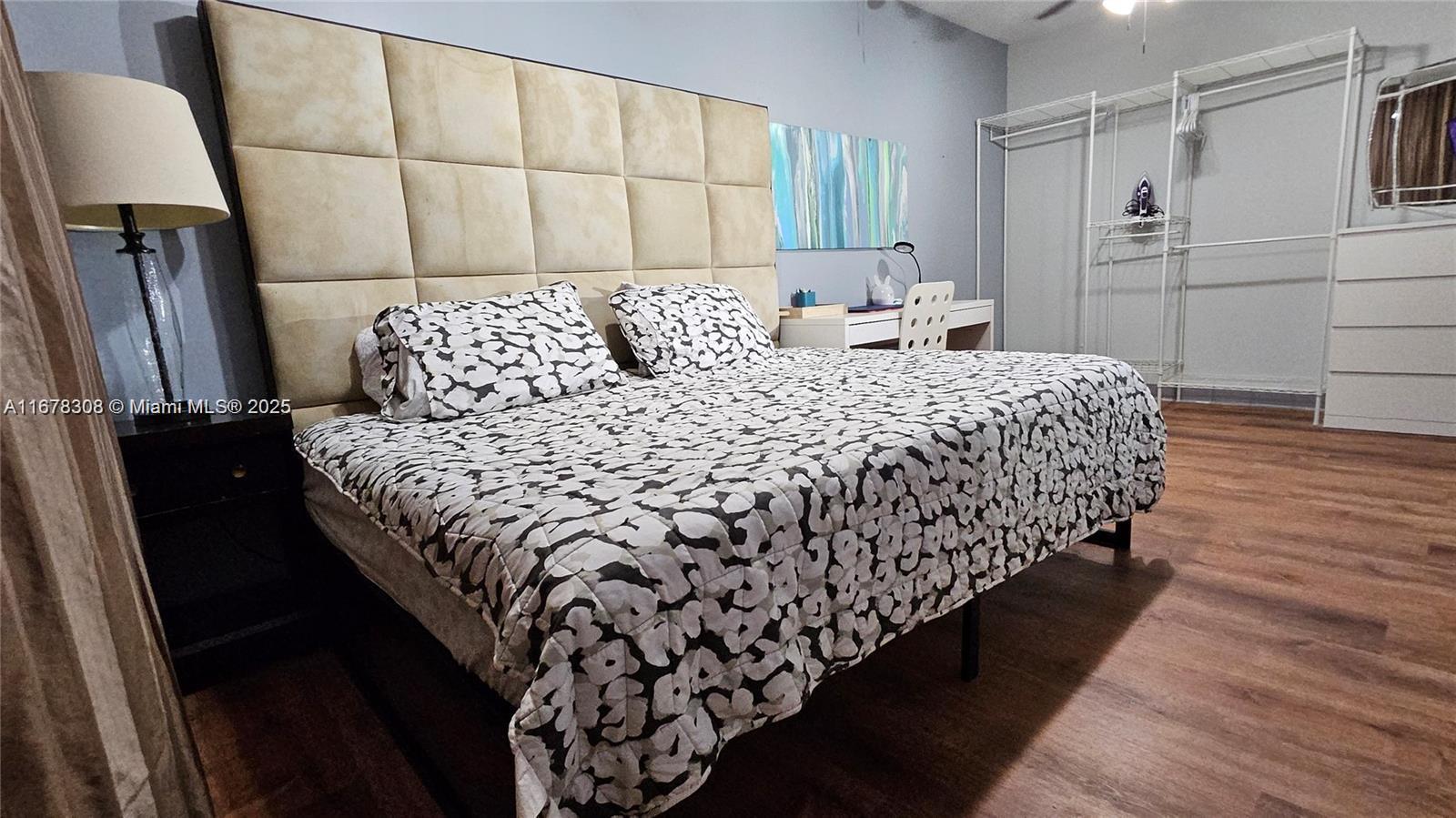 3600 Southwest S Le Jeune Road, Unit 3600 Coral Gables, FL 33134 - Photo 15 of 25 a bedroom with bed and wooden floor