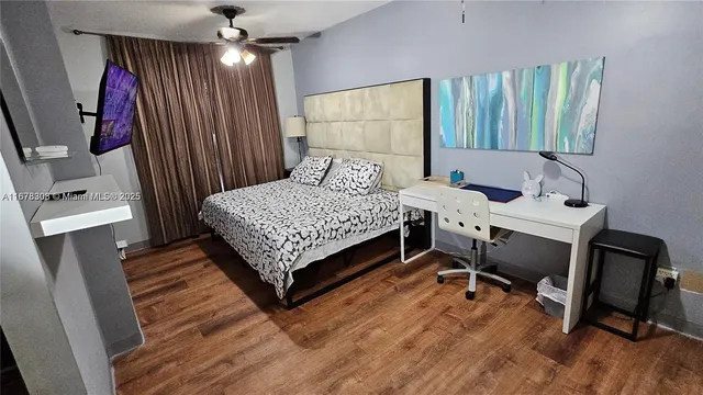 a bedroom with a bed window and chair