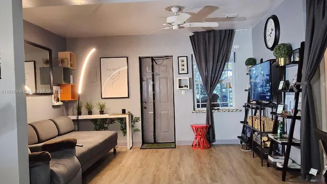 a living room with furniture bathtub and a flat screen tv