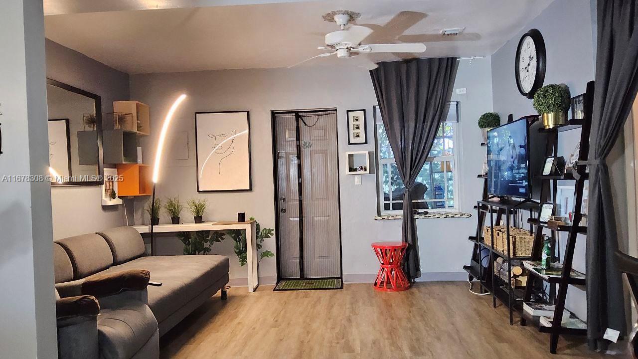 3600 Southwest S Le Jeune Road, Unit 3600 Coral Gables, FL 33134 - Photo 3 of 25 a living room with furniture bathtub and a flat screen tv