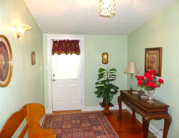 a view of a hallway with furniture and a potted plant