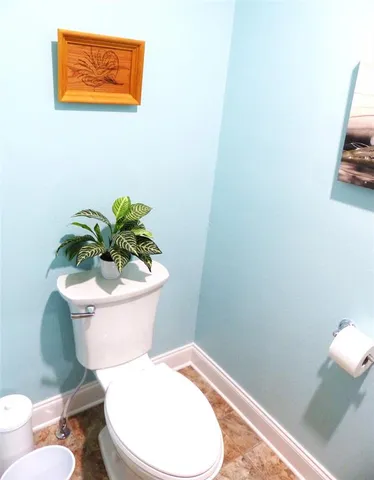 a white toilet sitting next to a bathroom sink