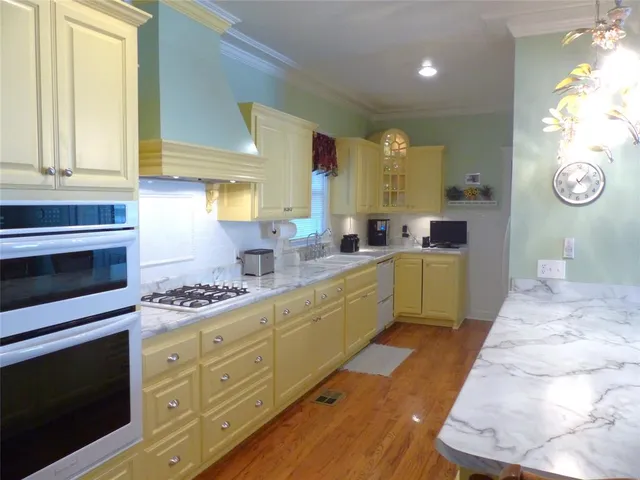 a kitchen with stainless steel appliances a stove a sink and a cabinets