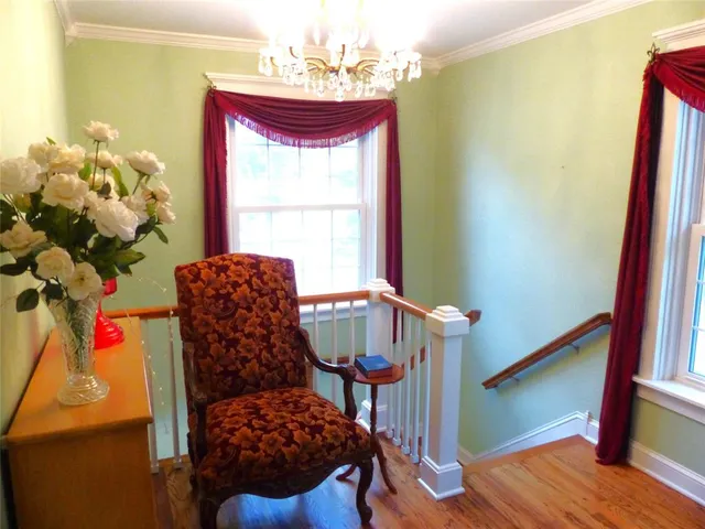 a balcony with furniture and a potted plant
