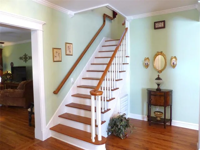 a view of entryway and hall with wooden floor