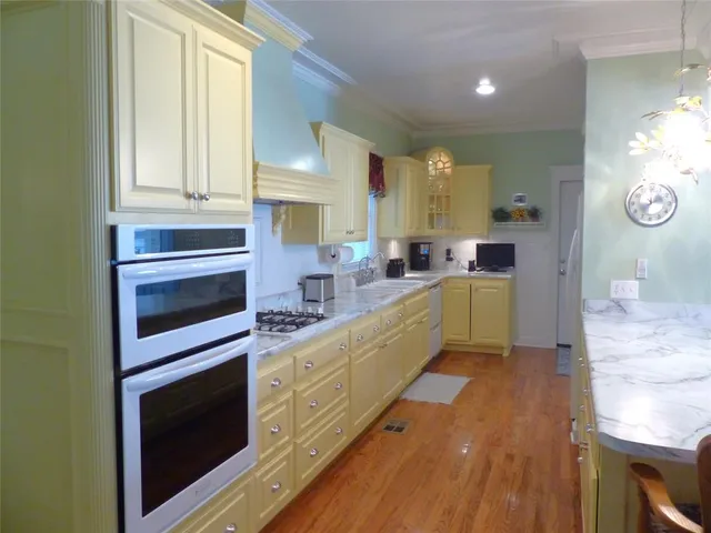 a kitchen with stainless steel appliances a stove sink and cabinets