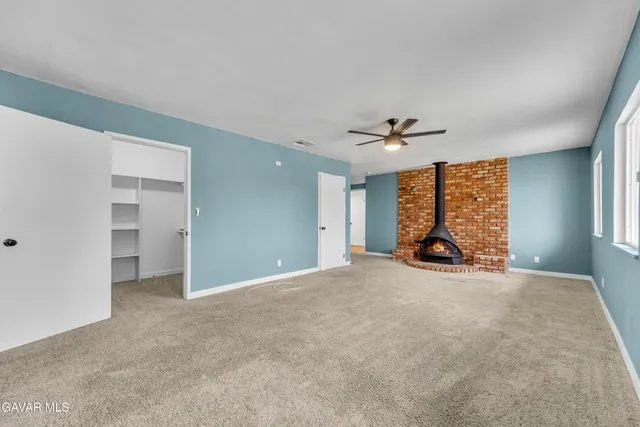 a large kitchen with a lot of counter space and wooden floor