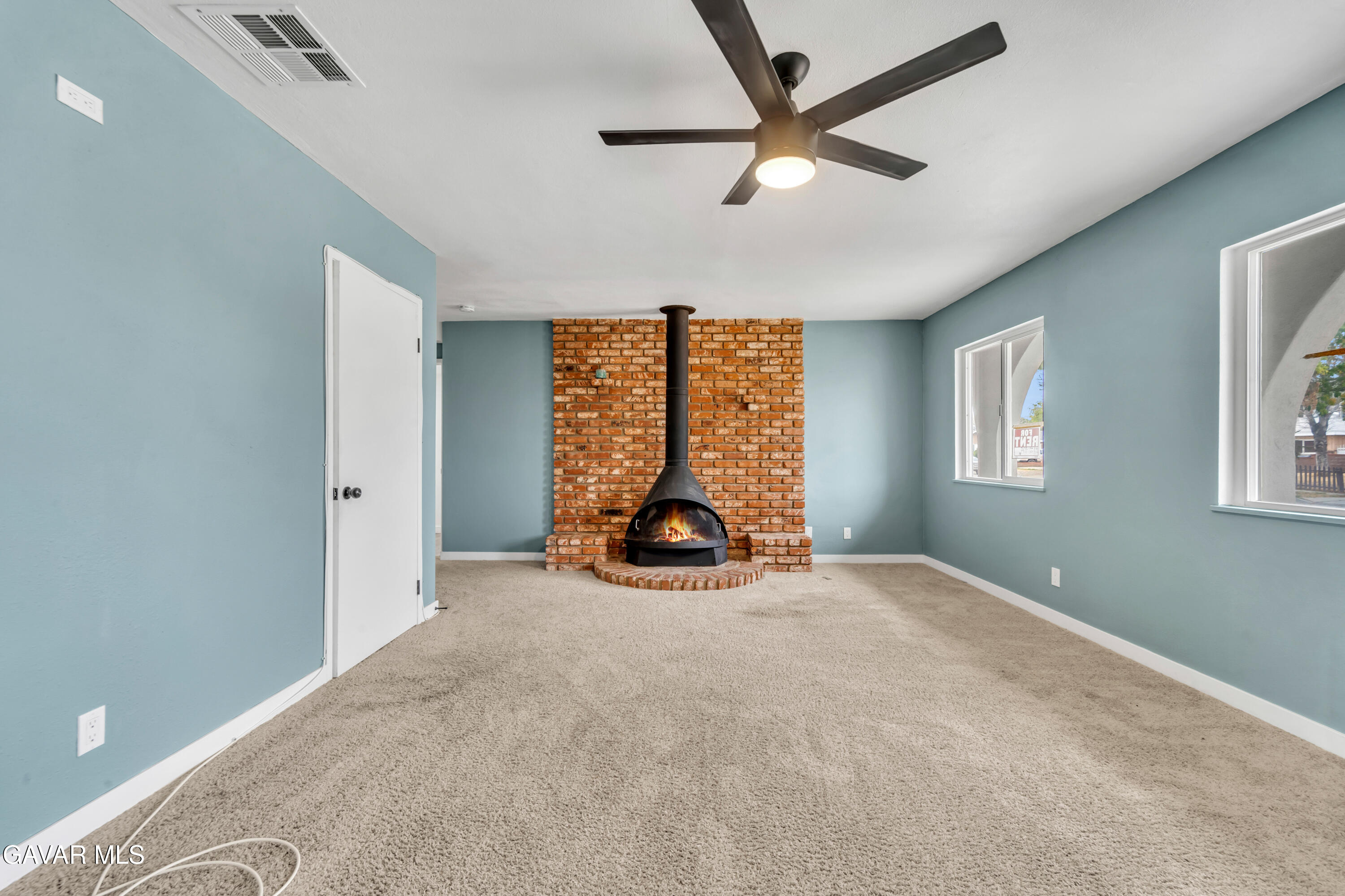 44526 Stanridge Avenue Lancaster, CA 93535 - Photo 13 of 26 an empty room with windows and fan