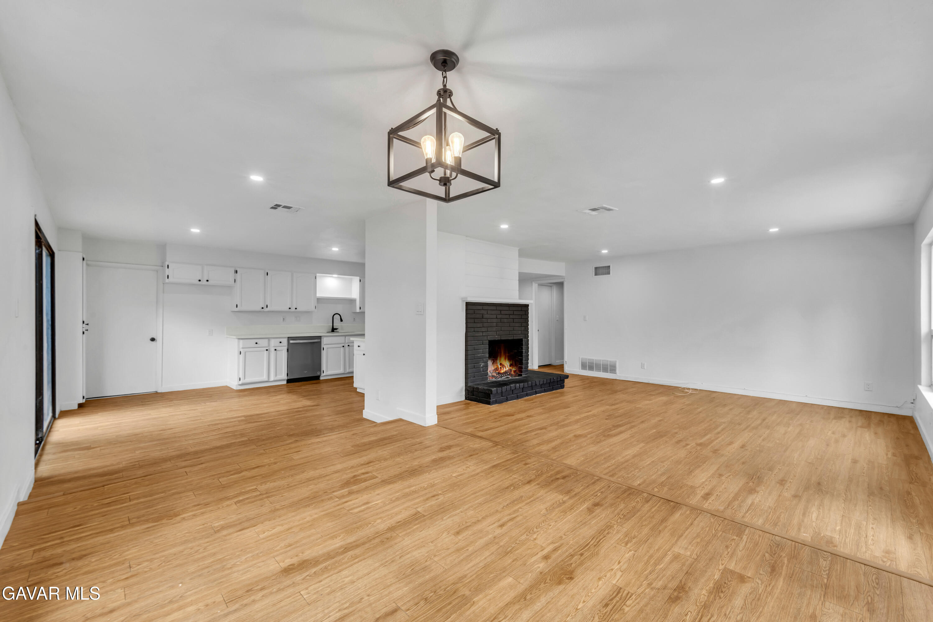 44526 Stanridge Avenue Lancaster, CA 93535 - Photo 18 of 26 an empty room with kitchen fireplace and windows
