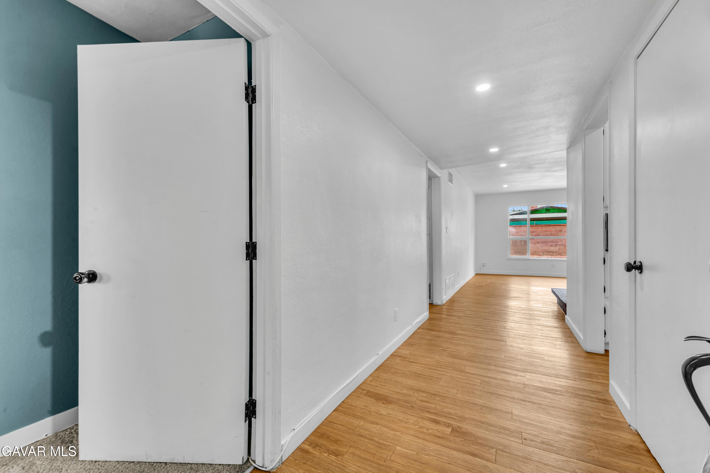 44526 Stanridge Avenue Lancaster, CA 93535 - Photo 10 of 26 a view of a hallway with wooden floor