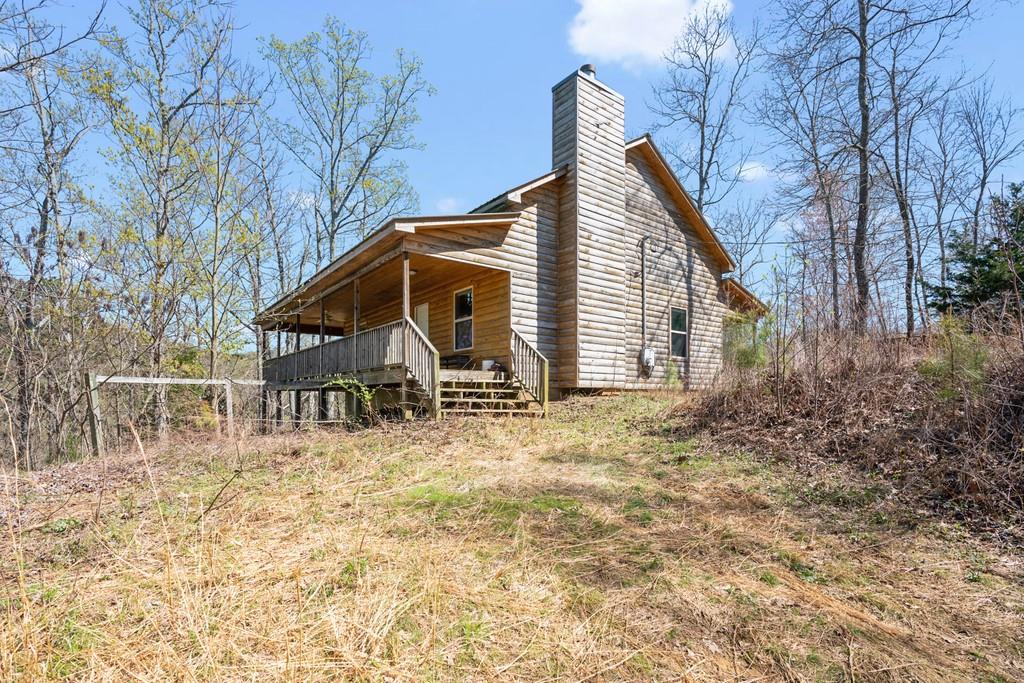 251 Dally Cove Road Northeast Ranger, GA 30734 - Photo 1 of 1 a view of house with backyard and trees in the background
