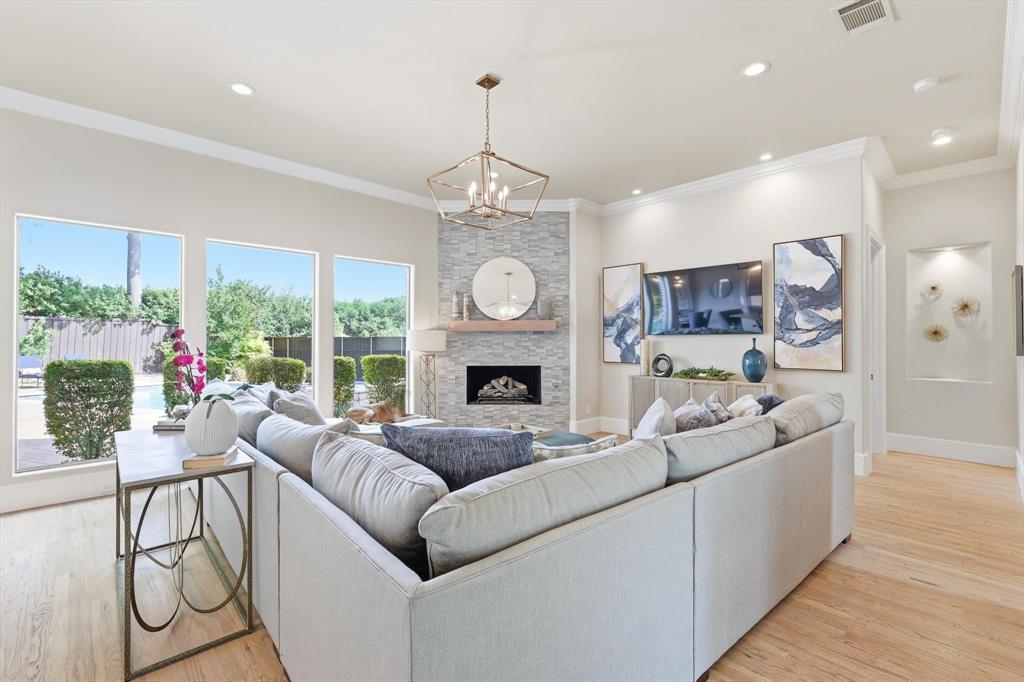 476 Hidden Valley Lane Coppell, TX 75019 - Photo 6 of 40 a living room with furniture a fireplace and a chandelier