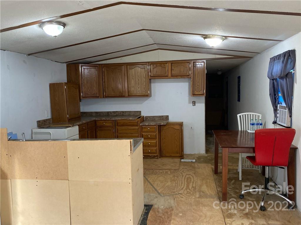 1454 Rhyne Road Clover, SC 29710 - Photo 7 of 8 a kitchen with stainless steel appliances kitchen island granite countertop a refrigerator and a stove