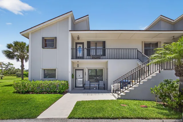 a front view of a house with yard and green space