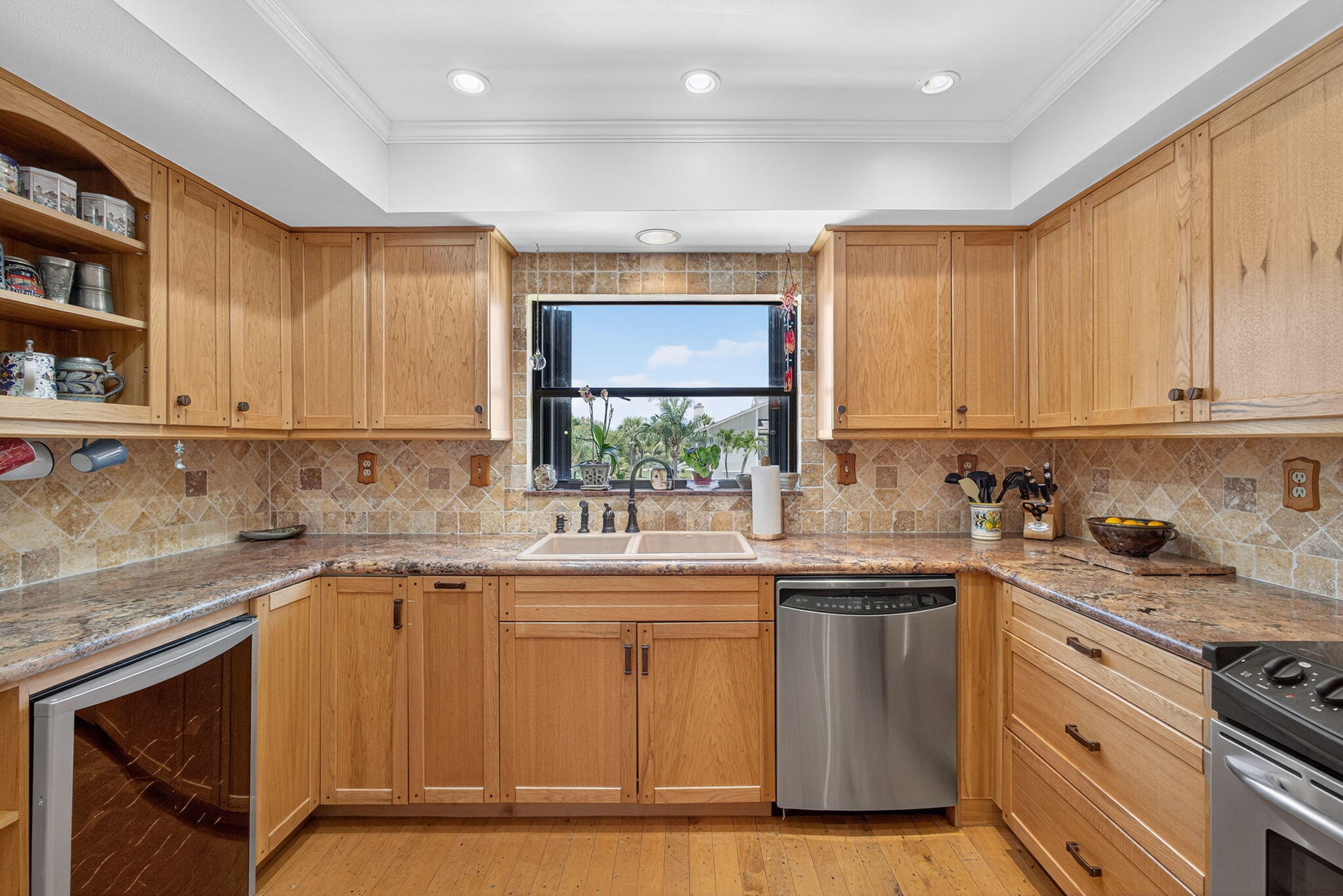 704 Clubhouse Circle Jupiter, FL 33477 - Photo 11 of 72 a kitchen with stainless steel appliances granite countertop a sink stove and cabinets