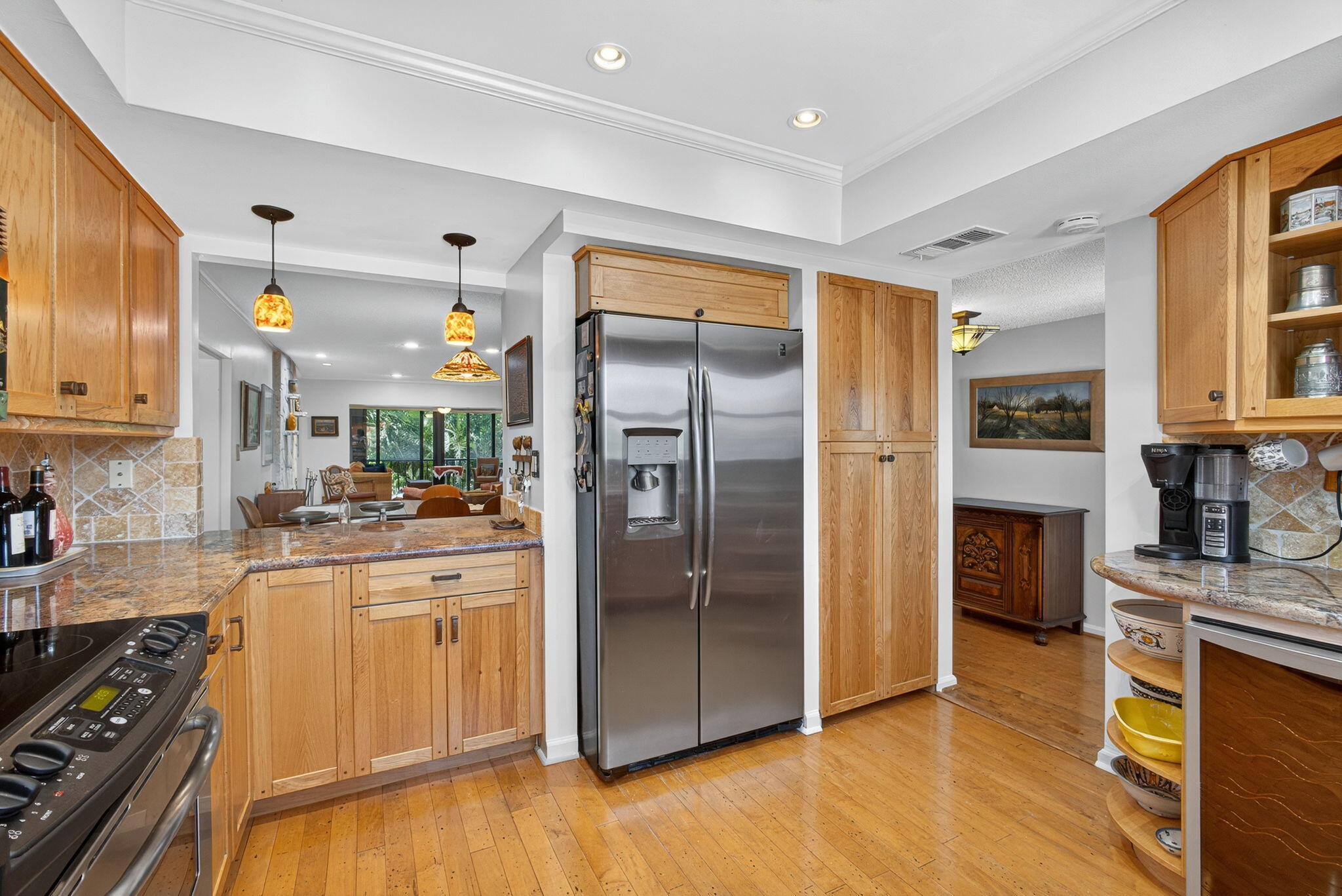 704 Clubhouse Circle Jupiter, FL 33477 - Photo 12 of 72 a kitchen with stainless steel appliances granite countertop a refrigerator and a stove top oven
