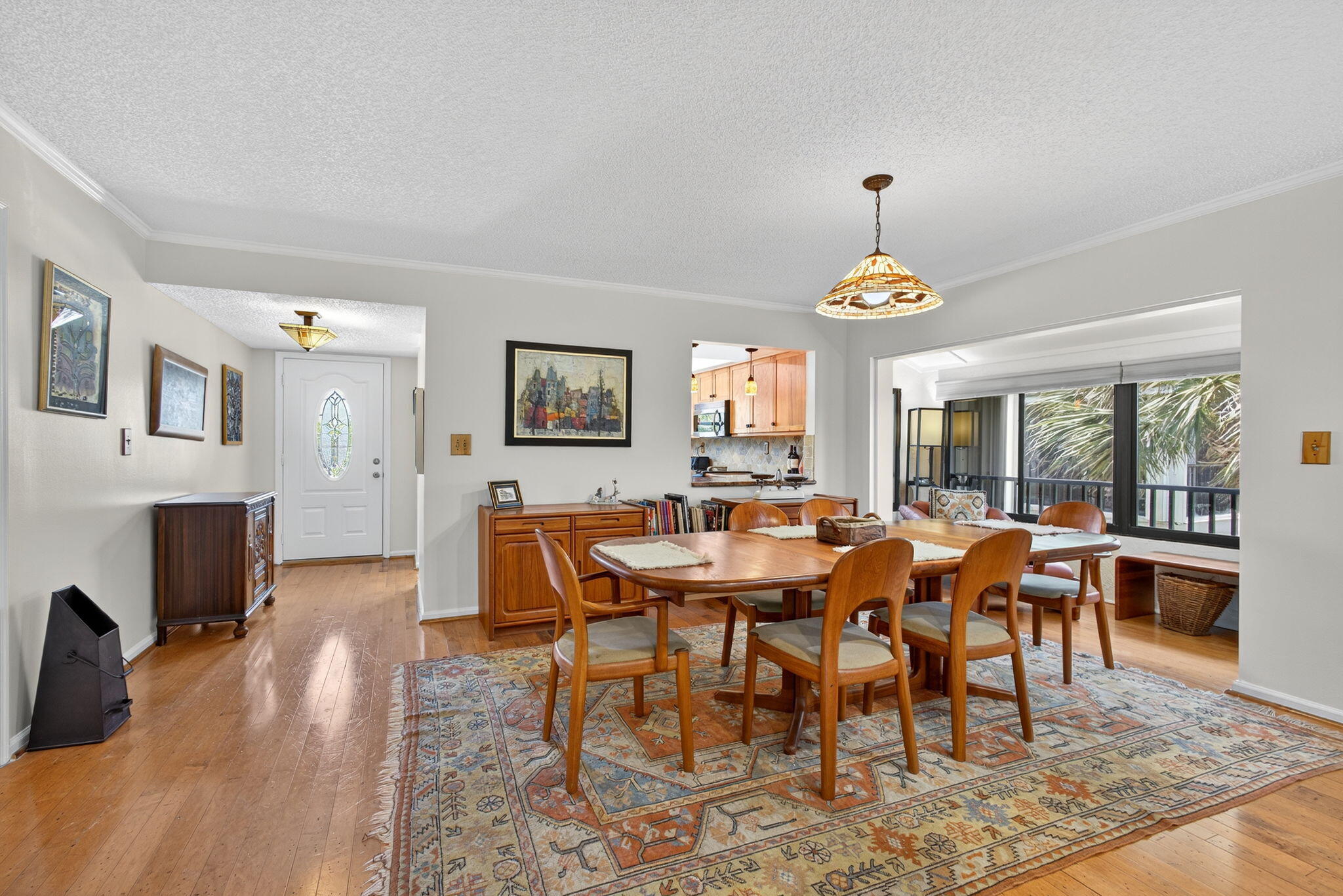 704 Clubhouse Circle Jupiter, FL 33477 - Photo 17 of 72 a dining room with furniture a chandelier and wooden floor