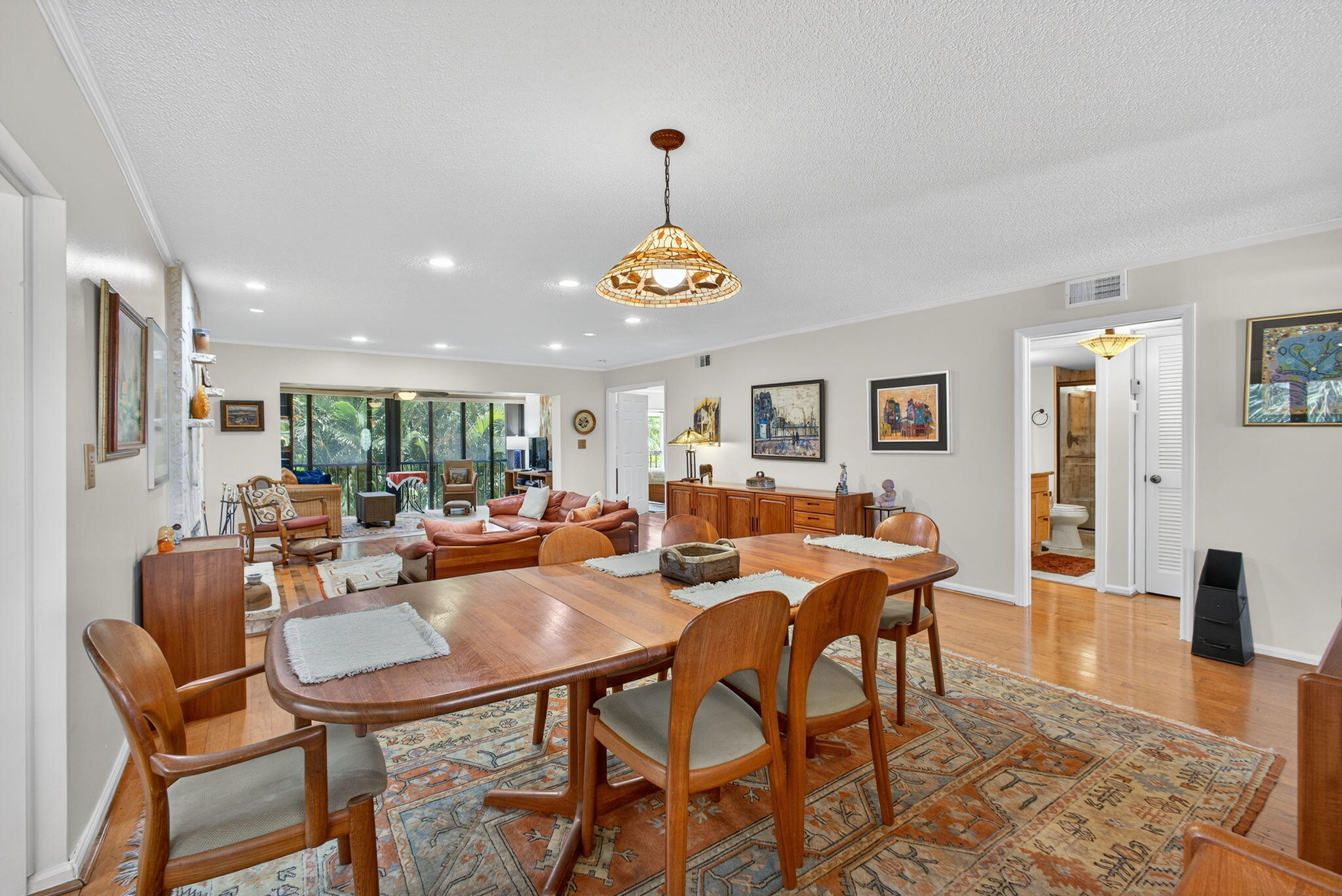 704 Clubhouse Circle Jupiter, FL 33477 - Photo 19 of 72 a dining room with wooden floor and a chandelier