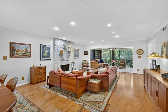 a living room with furniture a flat screen tv and a large window