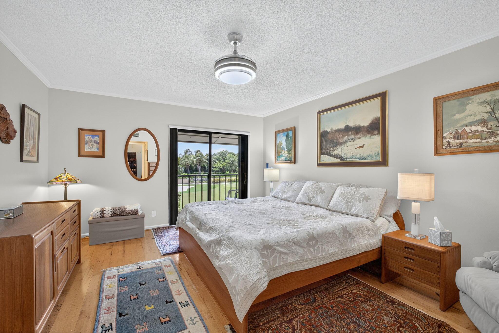 704 Clubhouse Circle Jupiter, FL 33477 - Photo 36 of 72 a bedroom with a bed a chandelier and a dresser