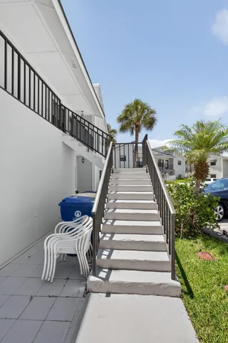 an aerial view of residential houses with outdoor space and lake view