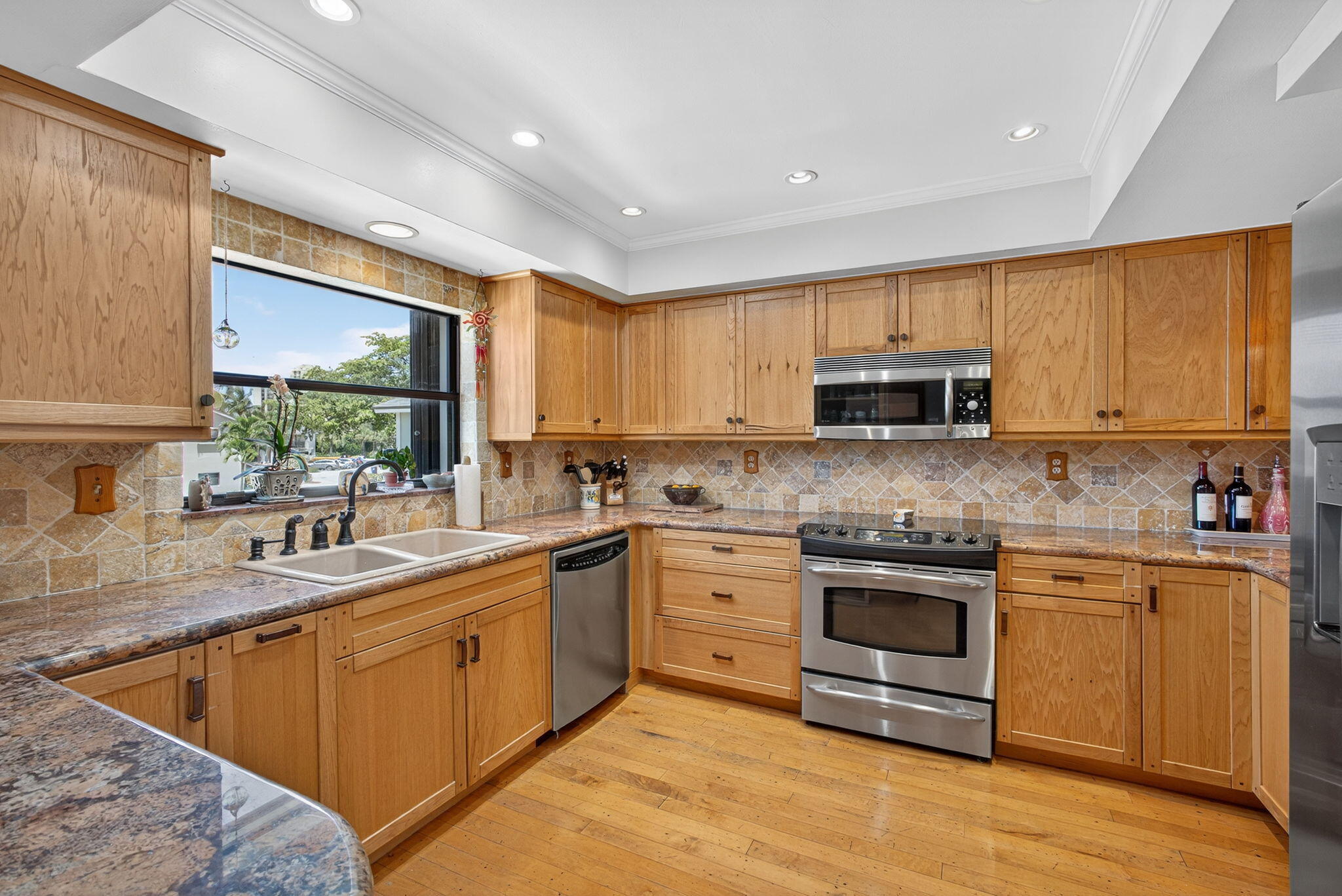 704 Clubhouse Circle Jupiter, FL 33477 - Photo 9 of 72 a kitchen with stainless steel appliances granite countertop a sink and cabinets
