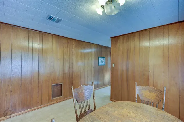 a view of a livingroom with furniture and chandelier fan