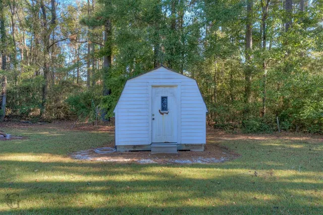 a view of backyard with large trees