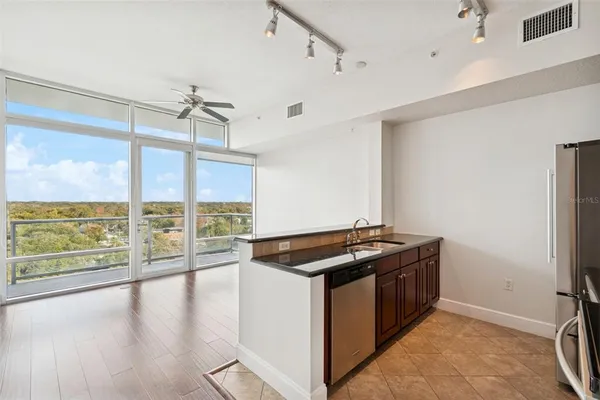 a kitchen that has a stove and a wooden floor