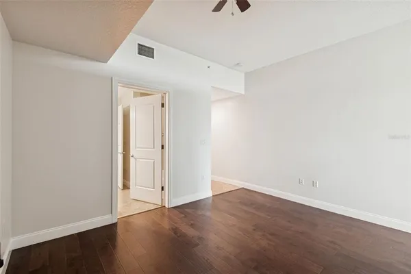 a view of an empty room with wooden floor