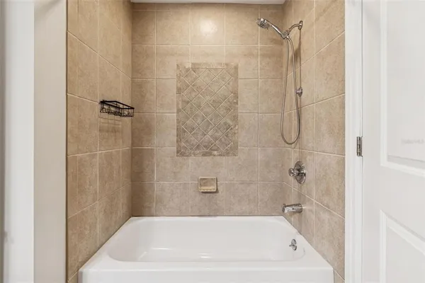 a bath tub sitting next to a shower
