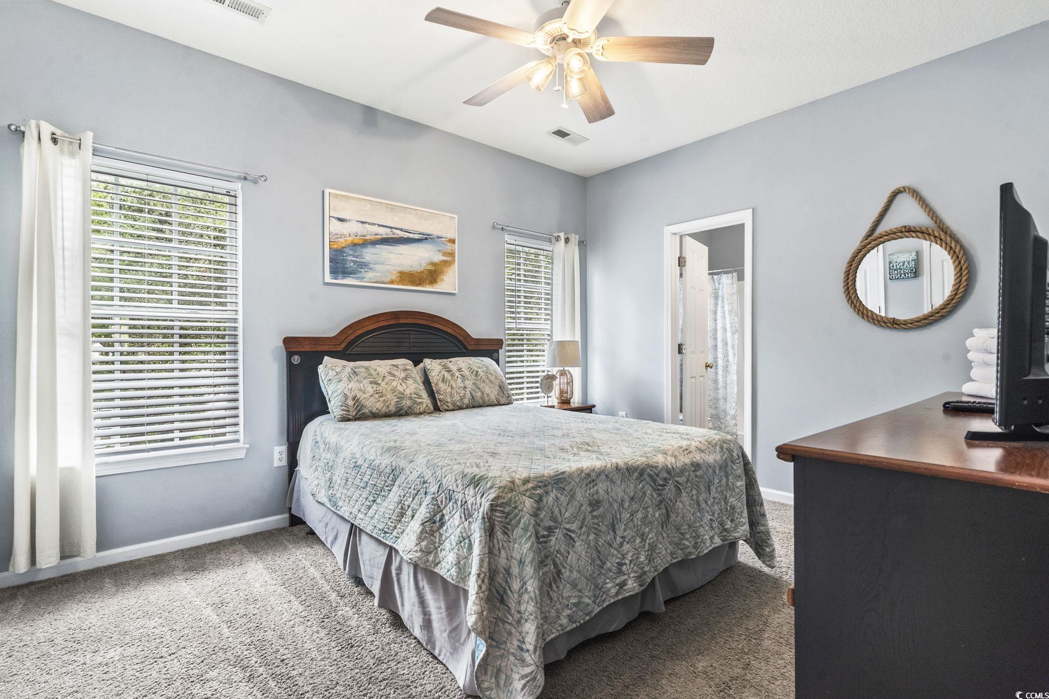 105 B Woodland Drive Murrells Inlet, SC 29576 - Photo 11 of 21 Carpeted bedroom with ceiling fan and connected bathroom