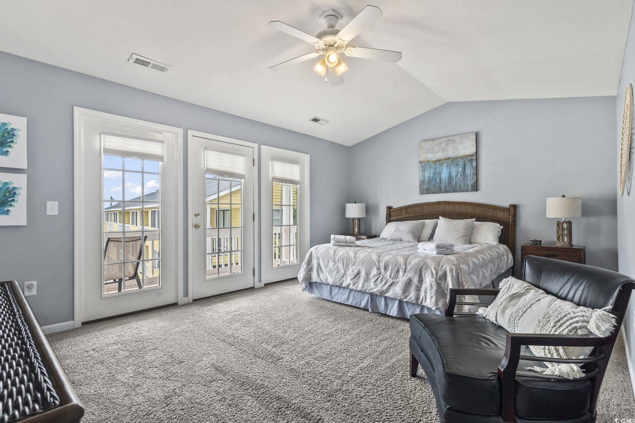 105 B Woodland Drive Murrells Inlet, SC 29576 - Photo 12 of 21 Bedroom featuring carpet floors, access to exterior, lofted ceiling, and ceiling fan